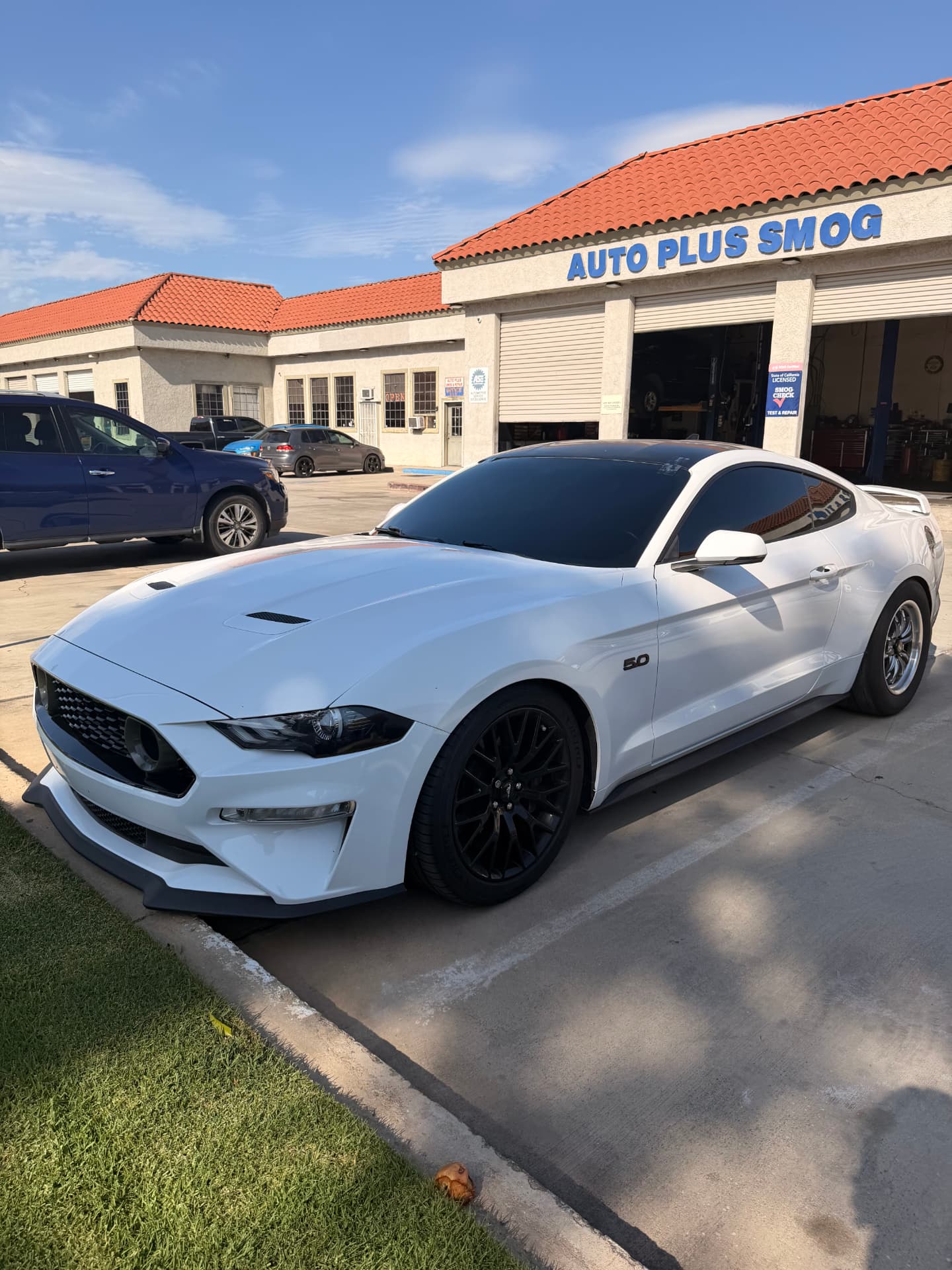 White Ford Mustang GT with freshly tinted windows