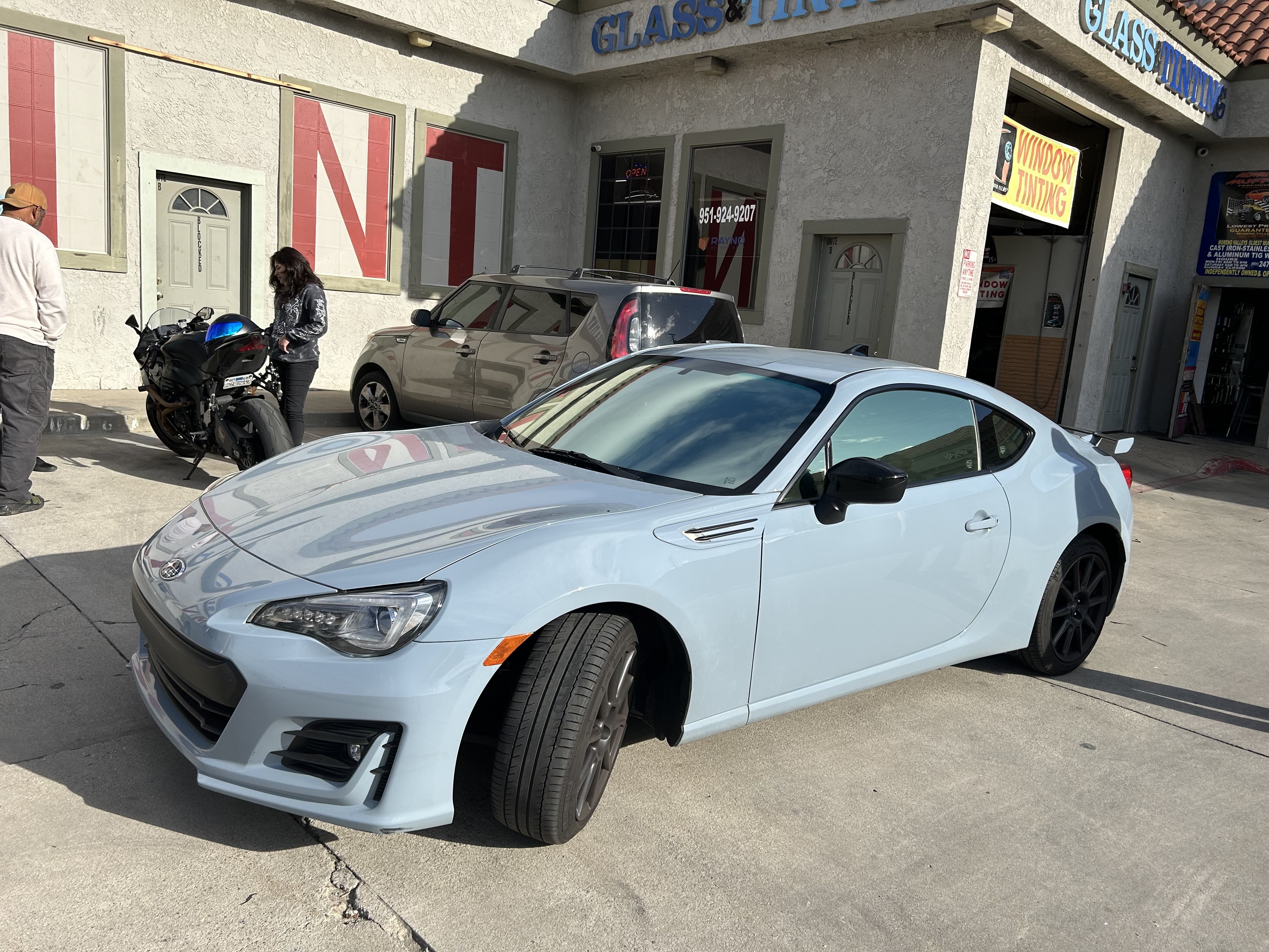 White Toyota 86 with fresh window tint parked outside the shop